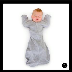 Transition swaddle sack with arms up cuffs